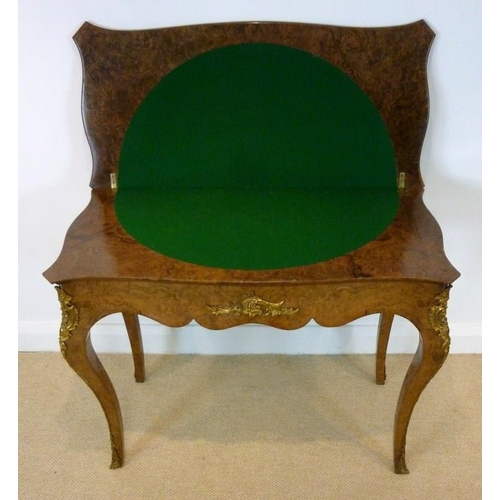 1059 - A Victorian burr walnut card table, circa 1870, the mirror veneered serpentine top with a moulded ed... 