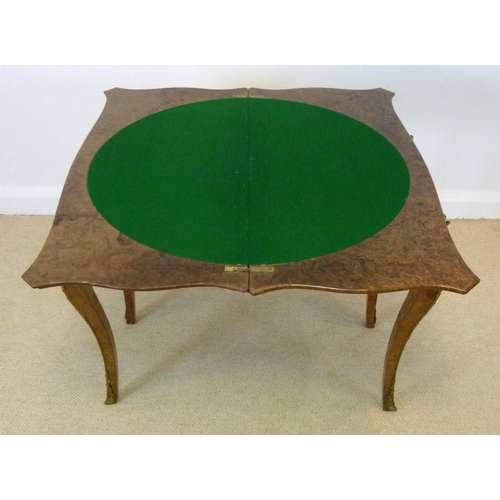 1059 - A Victorian burr walnut card table, circa 1870, the mirror veneered serpentine top with a moulded ed... 