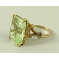 A 14ct gold and pale green tourmaline dress ring, with a single emerald cut tourmaline, 16 by 14mm, ... 