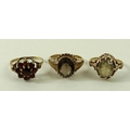 A 9ct gold and smoky quartz ring, the solitaire oval stone in an open setting, size L, 3.4g, a simil... 