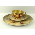 A Royal Worcester cabinet plate, decorated with plums and gooseberries, 23cm, and a tea cup and sauc... 