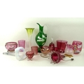 A collection of cranberry glass comprising vases, glasses, jug, bell, and cup, together with a Mary ... 