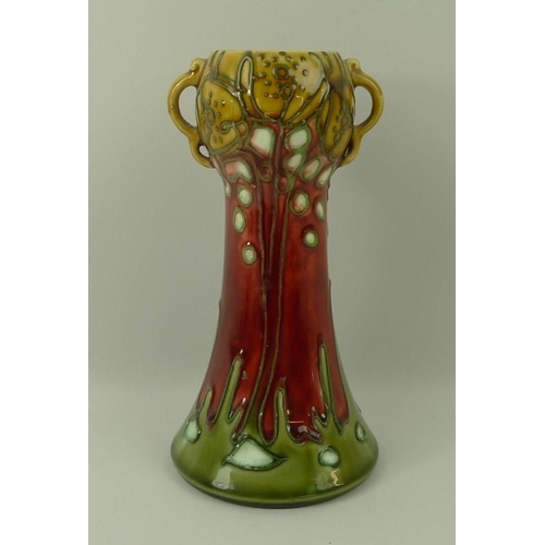 512 - A Minton Secessionist vase, of tapered and gourd design with twin handles, tube line decorated with ... 