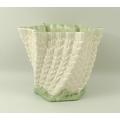 A Belleek handkerchief and shell design vase, the base and rim edged in green, 14 by 11cm.