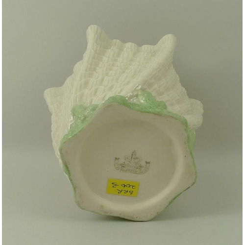 516 - A Belleek handkerchief and shell design vase, the base and rim edged in green, 14 by 11cm.