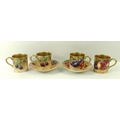 A Royal Worcester collection of four coffee cans and two saucers, decorated with apples, raspberries... 