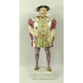 A porcelain figure of Henry VIII, mid 20th century, modelled after Hans Holbein, standing holding hi... 