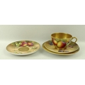 A Royal Worcester trio comprising tea cup, saucer and plate, painted with plums, raspberries and gra... 