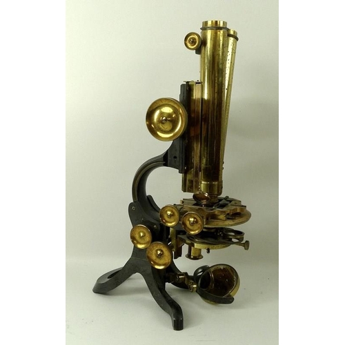 654A - A brass and black enamelled binocular compound microscope, by Swift & Son, London, with a lacquered ... 