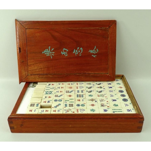 656A - A Mah Jong set with bamboo and bone, boxed, 17 by 27 by 5cm.