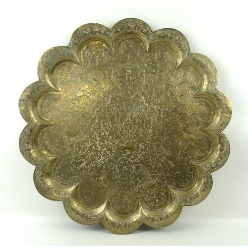 660 - An Indian brass lobed tray, intricately engraved, 57cm.