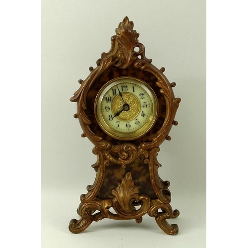 683 - A faux tortoiseshell mantel clock, the face with Arabic numerals, with scrolling frame, circa 1910, ... 