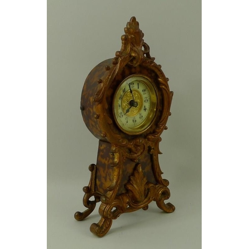 683 - A faux tortoiseshell mantel clock, the face with Arabic numerals, with scrolling frame, circa 1910, ... 