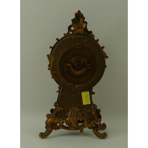 683 - A faux tortoiseshell mantel clock, the face with Arabic numerals, with scrolling frame, circa 1910, ... 