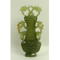A Chinese jade carved lidded urn, circa 1930's, with dolphin head finials, and ring handles, 14cm, b... 