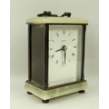 A Tempora carriage clock, with onyx base and top, with three metal side, carrying handle, and four f... 