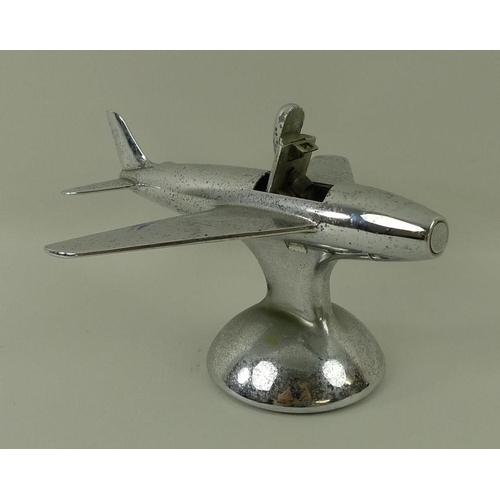 694A - A Dunhill novelty electroplated table lighter, circa 1950, in the form of a jet aeroplane, on a dome... 