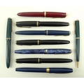 A collection of fountain pens including a Parker 585, black, with 14ct gold nib, two black Parker Du... 