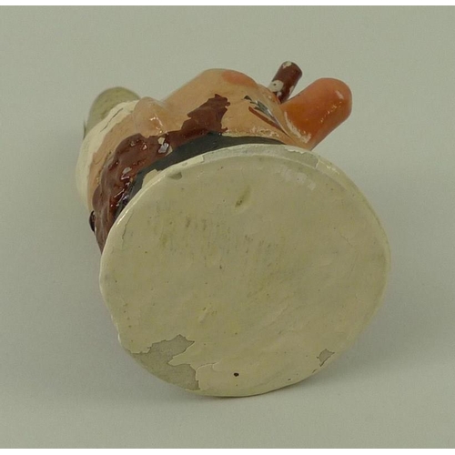 708 - A 1930's papier mache bottle stop of a H.M.S sailor with cigar, on a cork stopper, 12cm.