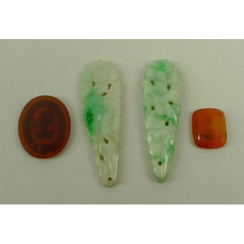 714 - A pair of jade carved and pierced drops, an unmounted intaglio with coronet and lion, and an agate s... 