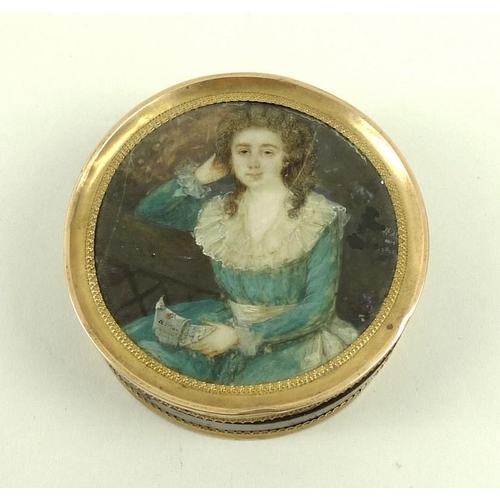 717 - A faux tortoiseshell pill box, with painted lid, the circular miniature of a Georgian lady holding a... 