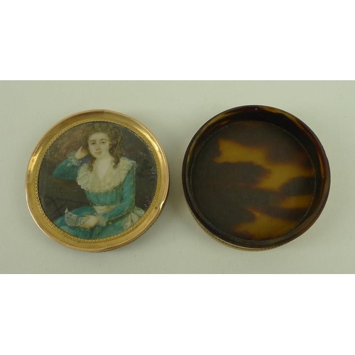 717 - A faux tortoiseshell pill box, with painted lid, the circular miniature of a Georgian lady holding a... 