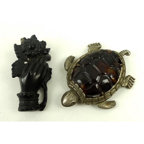 720 - A vesta case in the form of a turtle with white metal body and tortoiseshell back, and an ebony mour... 