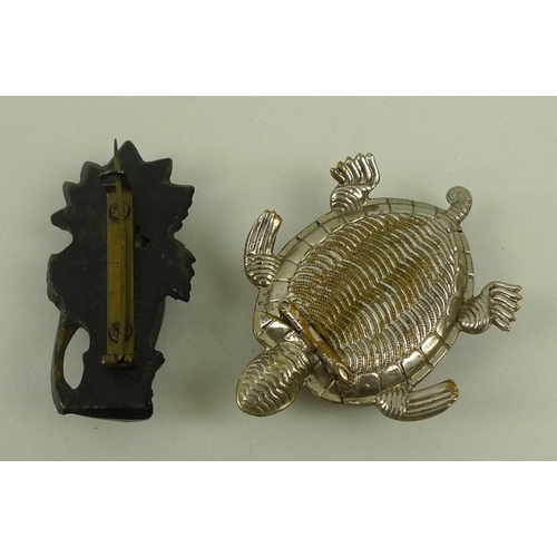 720 - A vesta case in the form of a turtle with white metal body and tortoiseshell back, and an ebony mour... 