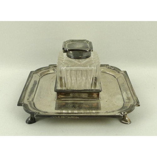 737 - A silver desk inkwell on stand, the cut glass inkwell of square form with silver lid, the stand with... 