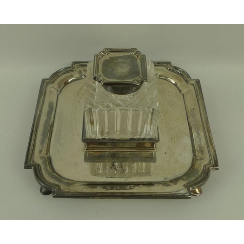 737 - A silver desk inkwell on stand, the cut glass inkwell of square form with silver lid, the stand with... 