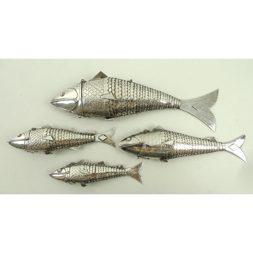 740 - A group of four Chinese white metal articulated fish, of graduated size, from 11cm to 20cm, the head... 