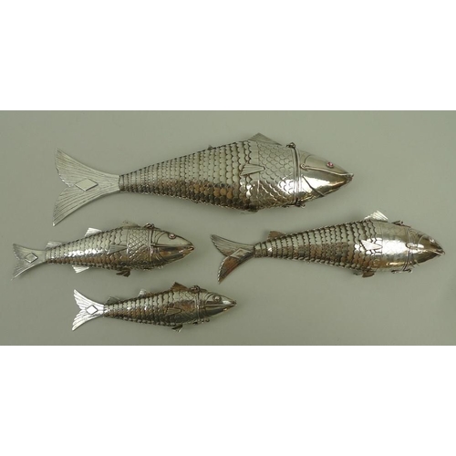 740 - A group of four Chinese white metal articulated fish, of graduated size, from 11cm to 20cm, the head... 