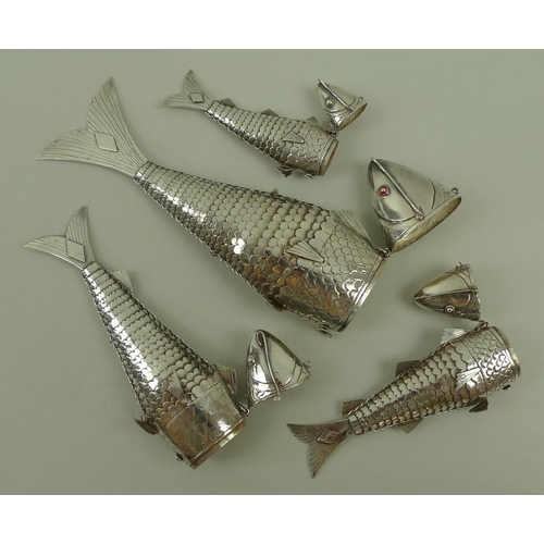 740 - A group of four Chinese white metal articulated fish, of graduated size, from 11cm to 20cm, the head... 