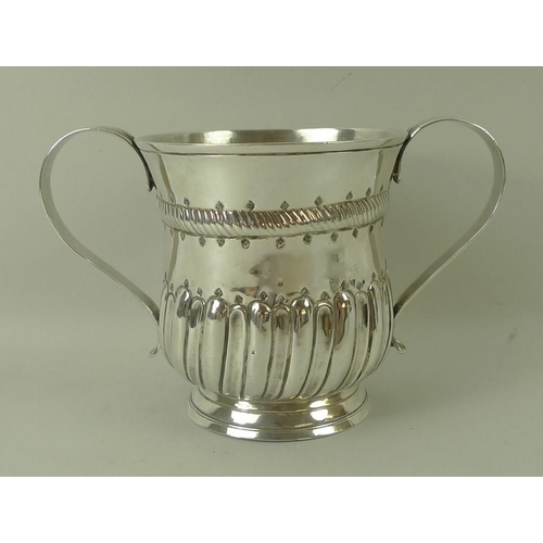 746 - A George III silver porringer two handled cup, the baluster body decorated with a rope twist girdle,... 