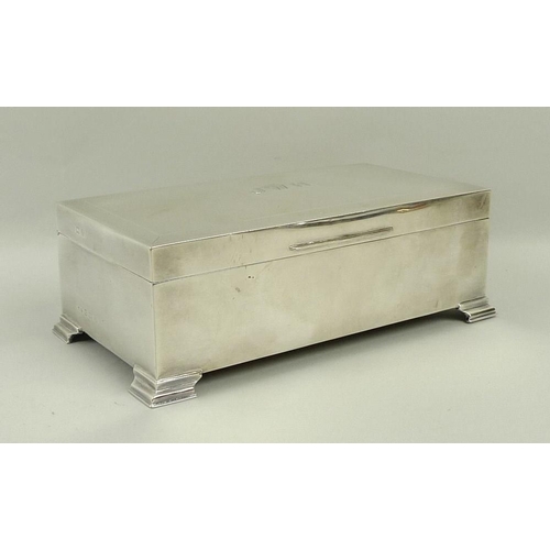 747 - A silver cigarette box, with stepped bracket feet and engine turned decoration, monogram engraved 'J... 