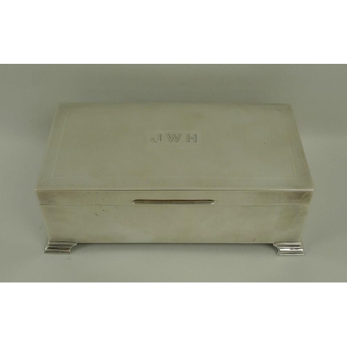 747 - A silver cigarette box, with stepped bracket feet and engine turned decoration, monogram engraved 'J... 