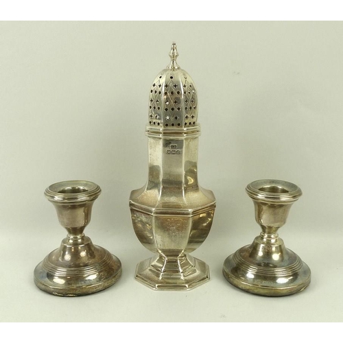 755 - A silver sugar shaker, Sheffield 1936, Edward Viner, 5.73toz, 18cm, and a pair of loaded silver cand... 