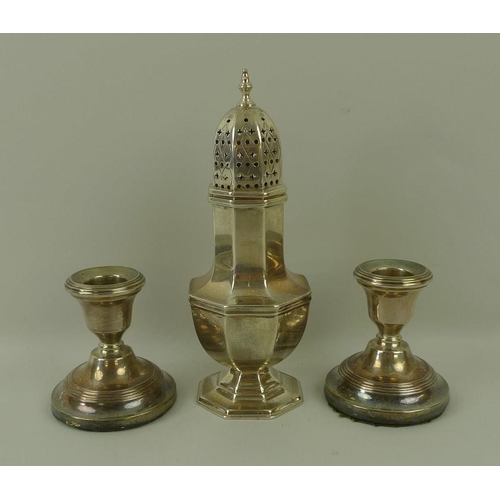 755 - A silver sugar shaker, Sheffield 1936, Edward Viner, 5.73toz, 18cm, and a pair of loaded silver cand... 