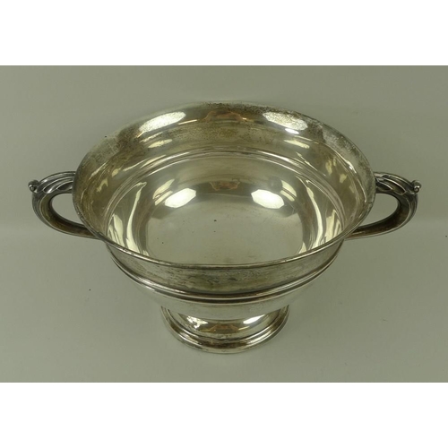 759 - A Walker and Hall silver trophy, of circular form with belted decoration, scroll handles and on a st... 