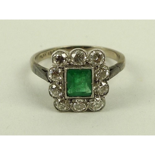 824 - An 18ct white gold, emerald and diamond ring, circa 1900, the central square cut emerald surrounded ... 