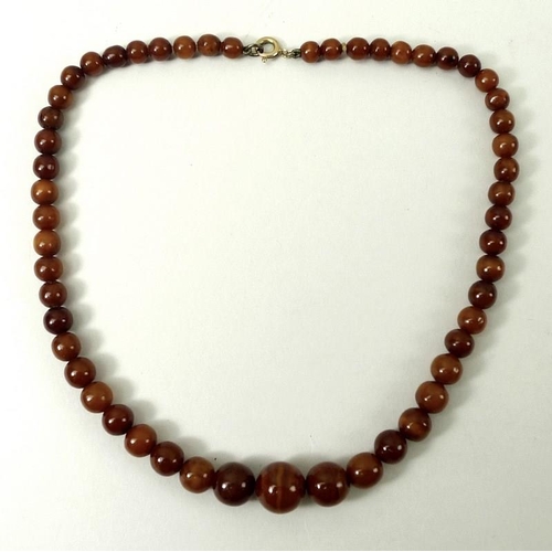 826A - A graduated amber bead necklace, early 20th century, fifty three beads from 6mm to 12mm, 39cm.