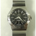 An Omega Constellation wristwatch, with steel casing and wrist band, black face with batons, and Rom... 