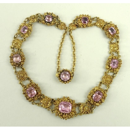 839 - A cannetille and pink topaz necklace, early 19th century, set with nine graduated stones divided by ... 