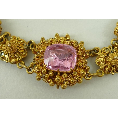 839 - A cannetille and pink topaz necklace, early 19th century, set with nine graduated stones divided by ... 