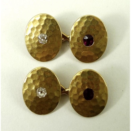 841A - A pair of textured gold, ruby and diamond set oval double cufflinks, unmarked but tests as at least ... 