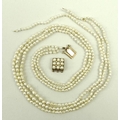 A three strand seed pearl necklace with a square 14ct gold clasp set with nine pearls and four seed ... 