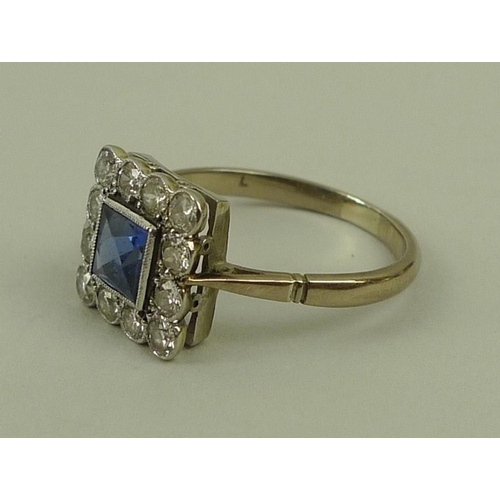 849 - An 18ct white gold, sapphire and diamond ring, circa 1900, the central square cut sapphire surrounde... 