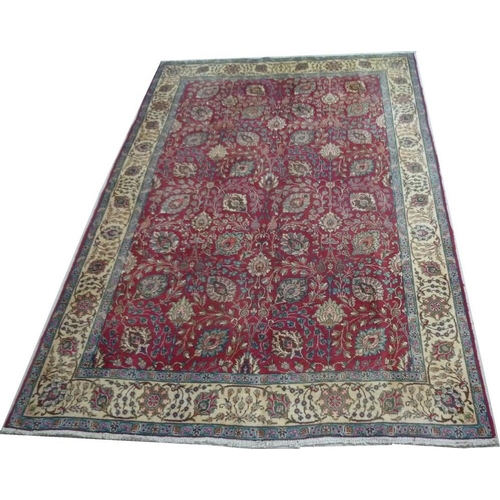 909 - A Tabriz rug, red ground wool on cotton all over flower-head vine and leaf pattern, about 80 years o... 