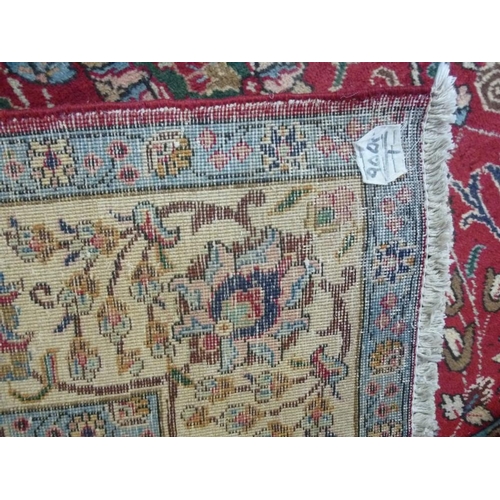 909 - A Tabriz rug, red ground wool on cotton all over flower-head vine and leaf pattern, about 80 years o... 