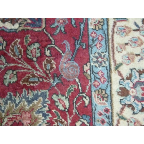 909 - A Tabriz rug, red ground wool on cotton all over flower-head vine and leaf pattern, about 80 years o... 